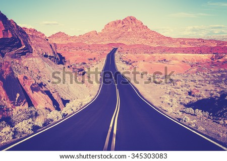 Vintage toned curved desert highway, travel concept, USA.