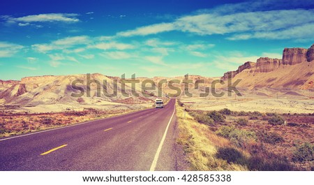 Vintage old film style picture of a highway in USA, focus on car, travel background.