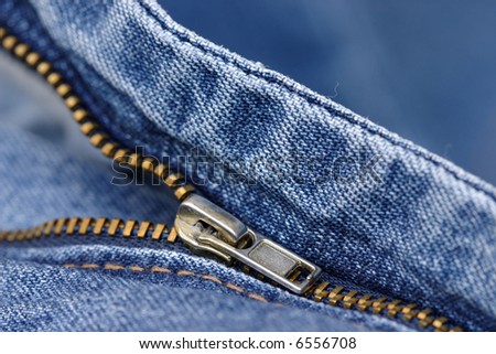 gold tone zipper on blue jeans