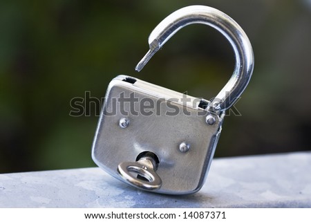 Open metal Padlock with key