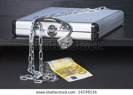Secured case with money on a black wooden shelf