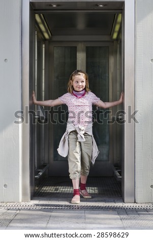 Girl standing in open elevator