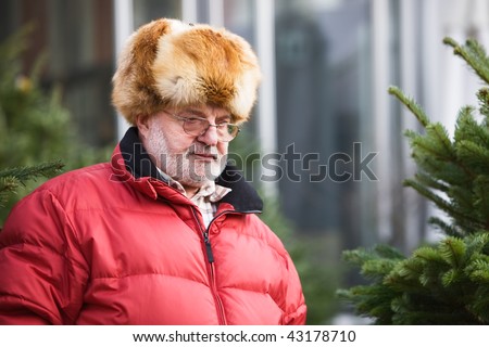Senior Man shopping for a Christmas Tree