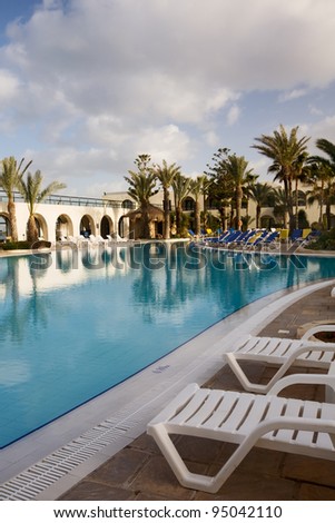 Lounge Chairs next to hotel swimming pool, island of Djerba, Tunisia, Africa