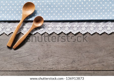 blue dot textile texture, wooden spoons on wood textured background