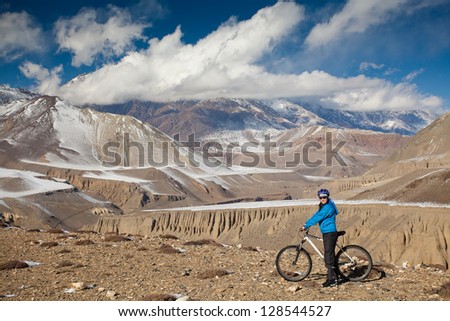 Woman cycling in Himalaya mountains during sunny day