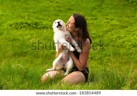 beautiful young happy laugh girl playing with her dog outdoor