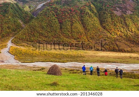 group of friends in hiking in high mountains. Admire the snow-capped peaks. Beautiful world
