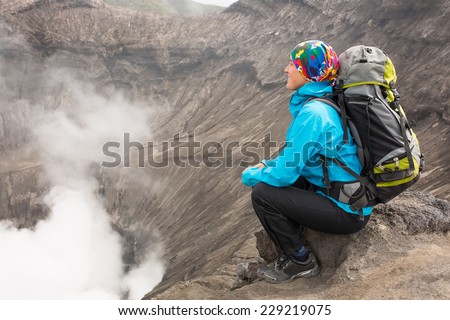 Hiking woman on top happy and celebrating success. Female hiker on top of the world cheering in winning gesture having reached summit of mountain