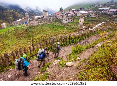 group of friends in hiking in high mountains. Approaching View of the village Adishi. Upper Svaneti, Georgia, Europe. Caucasus mountains. Beauty world. Beautiful world