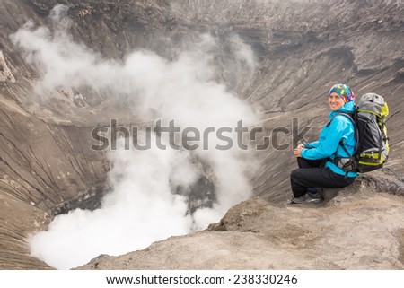 Hiking woman on top happy and celebrating success. Female hiker on top of the world cheering in winning gesture having reached summit of mountain