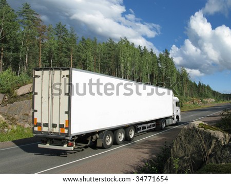 white truck on rural highway with dramatic clouds, rear view, slightly blurred in motion