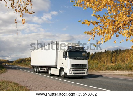 white truck on golden autumn highway, landscape
