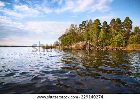 little island and  calm waves in Baltic sea, Vyborg bay