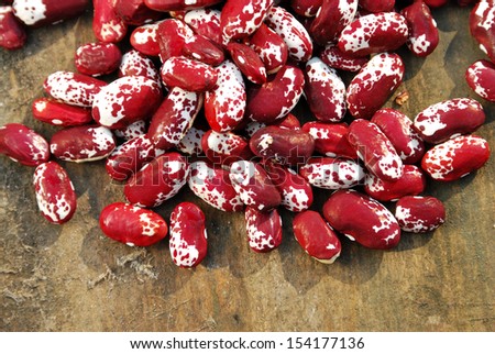 red and white beans on old wooden background