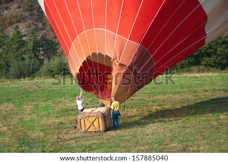 Two men inflate a balloon that could fly.