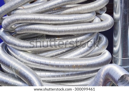 Big bunch of flexible aluminium hoses and pipes