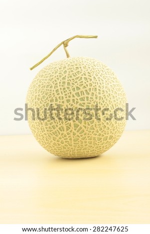 MELON\
Japanese green melon on the wood table with white background.