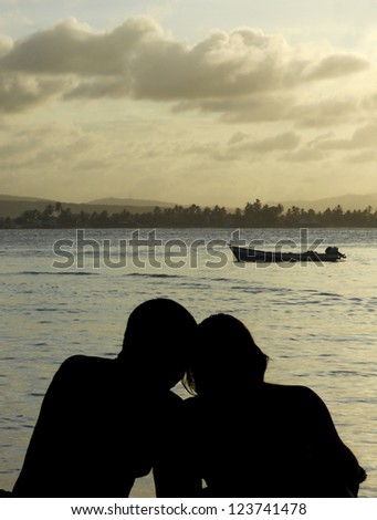 A romantic couple is enjoying the sunset in Caribbean sea. An ideal gift for St Valentine\'s day.