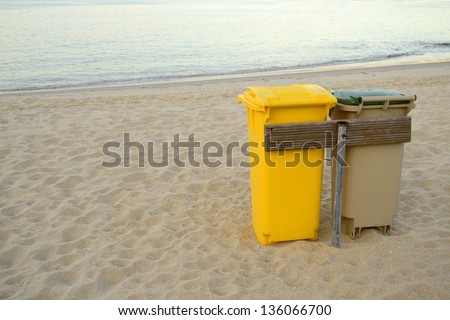 Couple of bins. Clean beach. Environmental care. Recyclability and sustainability