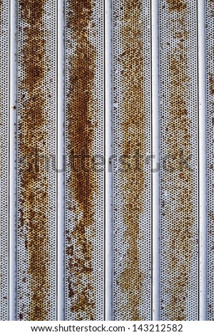 Metal with holes and vertical lines. Grungy texture. Black, white, red and yellow background