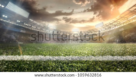 Sport background. Empty grand soccer stadium in the lights of sunset. Dramatic poster.