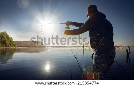 man fishing on a lake