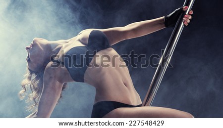 Sport. Pole dancer, woman dancing on pylon
