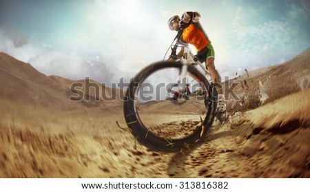Sport. Mountain Bike cyclist riding single track in desert