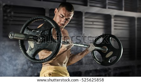 Sport, workout. Closeup portrait of a muscular man workout with barbell at gym.