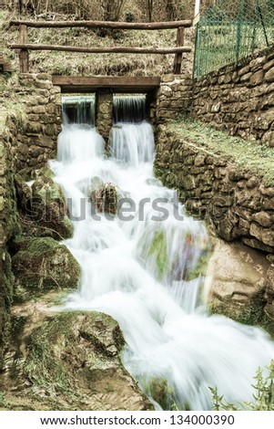 A small stream that feeds an old mill still working in Tuscany, Italy.