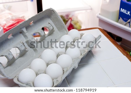 Carton of eggs and half gallon of milk in refrigerator