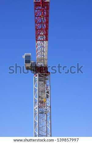 Crane operators cabin against a clear blue sky