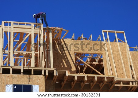 Home frame with construction worker present