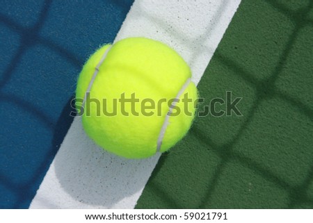 close up of tennis ball on the boundary line