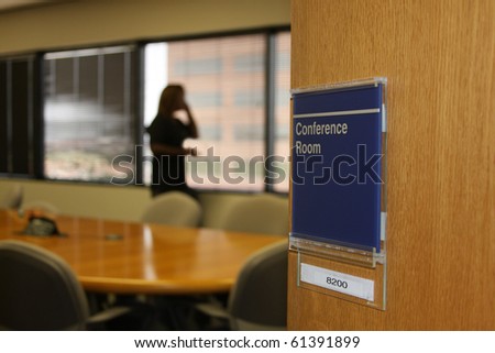 lady on phone in conference room at corporate office