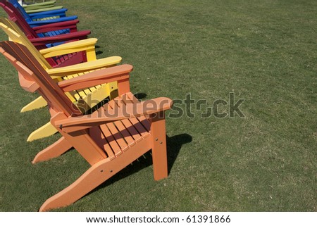 colorful lawn chairs sitting on green grass