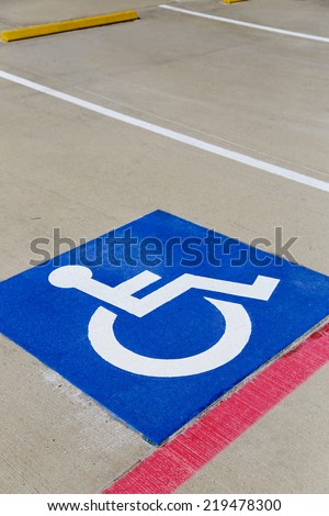 parking space with blue handicap icon painted inside
