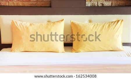 style bedroom interior with double yellow pillows.