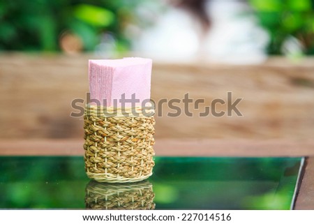 Tissue paper box on glass table in restaurant.