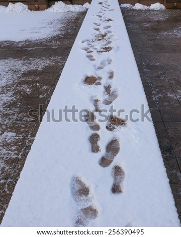 Footprints in fresh snow background great concept for winter footwear.