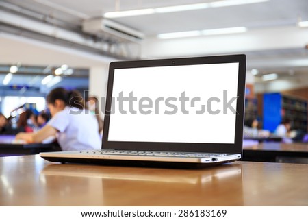 laptop with blank screen on the table in library.