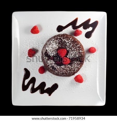Chocolate raspberry molten cake on a white plate