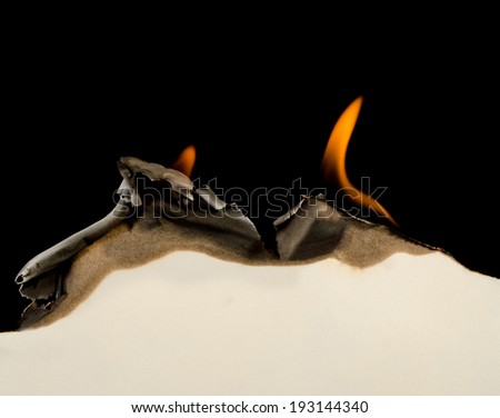 Curved edge of paper burnt and curled on a black background Curved edge of paper burnt and curled on a black background