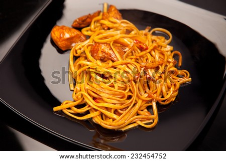 Hot asian noodle with chicken in soy sauce