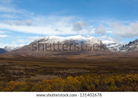 Wilderness of Alaska tundra in late fall with snow on mountains