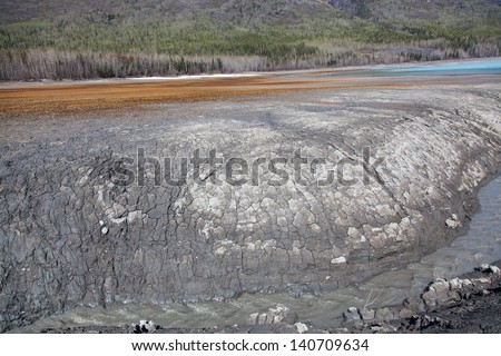 A wall of mud and clay near the end of a remote alpine lake