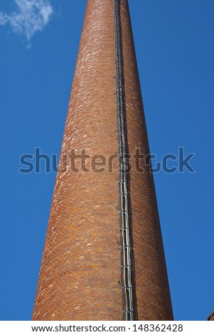 factory brick chimney against the sky