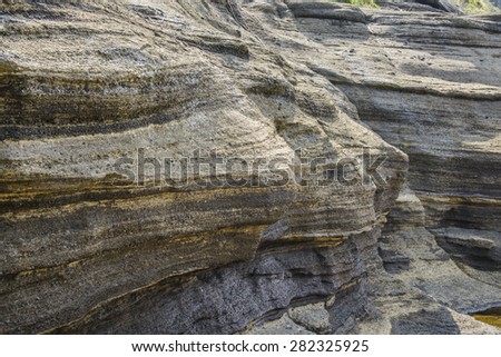 Multistory layered rough and strange sedimentary rocks in famous tourist site Yongmeori Coast(Dragon head coast) in Jeju Island, Korea.