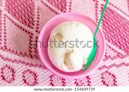 Coconut milk ice cream in a plastic cup pink.